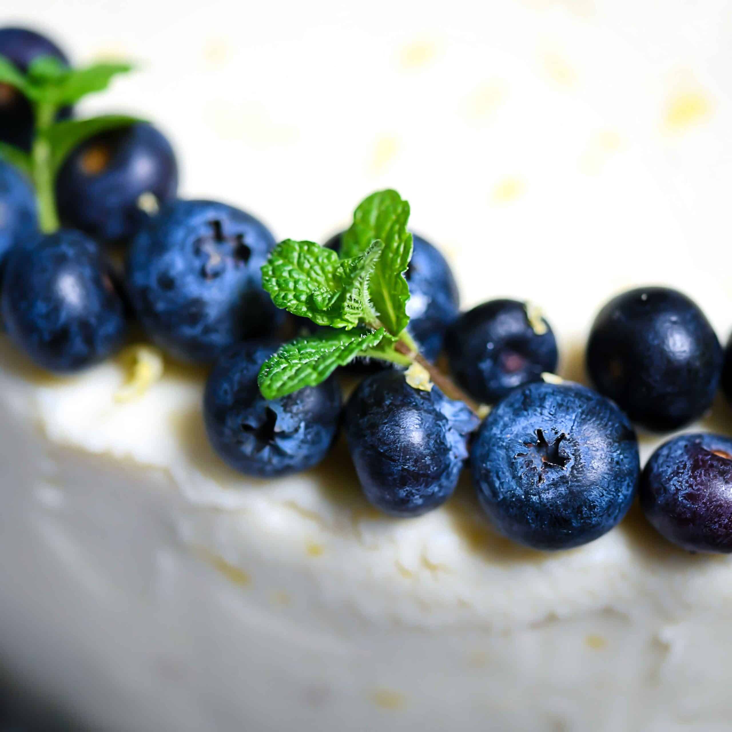 Closeup Blueberries, Mint on lemon cream cheese frosting